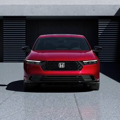 2026 Honda Accord in Radiant Red Metallic in minimalistic urban courtyard environment, straight front view.